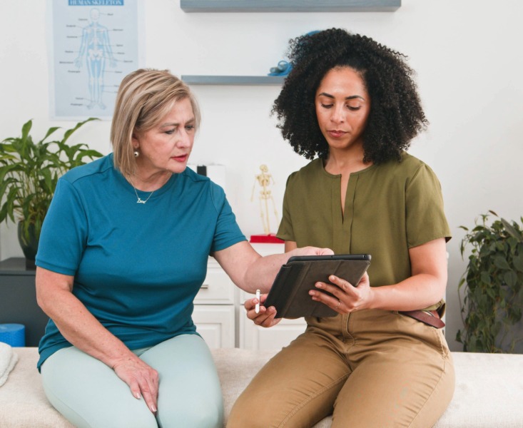 Physiotherapist Guides Senior Woman