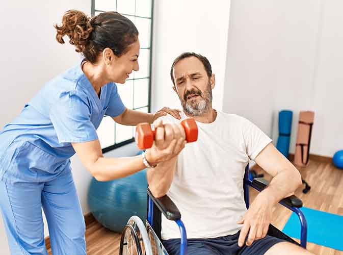 Rehabilitation specialists helping patient